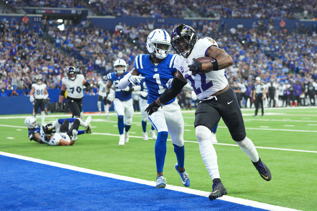 Baltimore Ravens' Derrick Henry runs for a touchdown past Indianapolis Colts' Sauce Gardner during the second half of an NFL football game Sunday, Sept. 13, 2026, in Indianapolis. (AP Photo/AJ Mast)