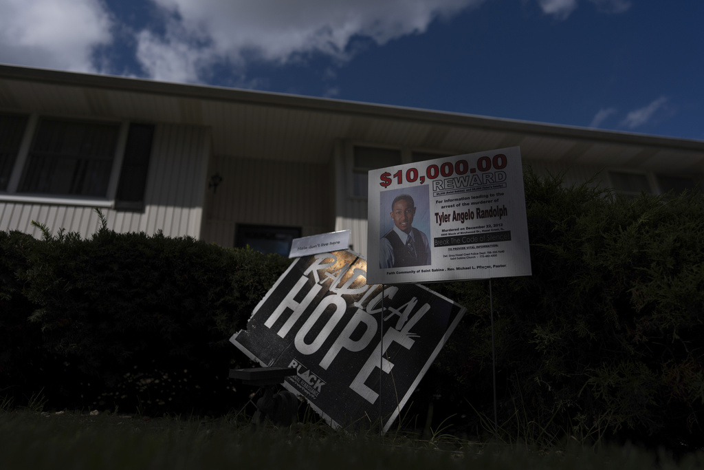 Signs are posted in front of Delphine Cherry's home Friday, Sept. 5, 2025, in Hazel Crest, Ill. Cherry lost two children, Tyler Randolph, and Tyesa Abney, to shootings in and near Chicago. (AP Photo/Carolyn Kaster)