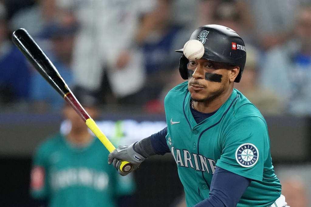 Seattle Mariners' Jorge Polanco (7) fouls off a pitch against the Toronto Blue Jays during the eighth inning of Game 6 of baseball's American League Championship Series in Toronto, Sunday, Oct. 19, 2025. (Nathan Denette/The Canadian Press via AP)