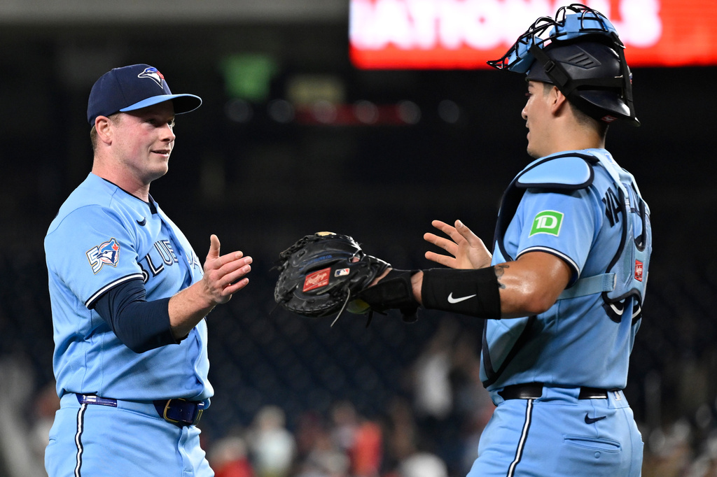 Toronto Blue Jays closing pitcher Louis Varland, left, is congratulated by Blue Jays catcher Brandon Valenzuela after getting a save during the ninth inning of a baseball game against the Washington Nationals, Monday, July 27, 2026, in Washington. (AP Photo/John McDonnell)