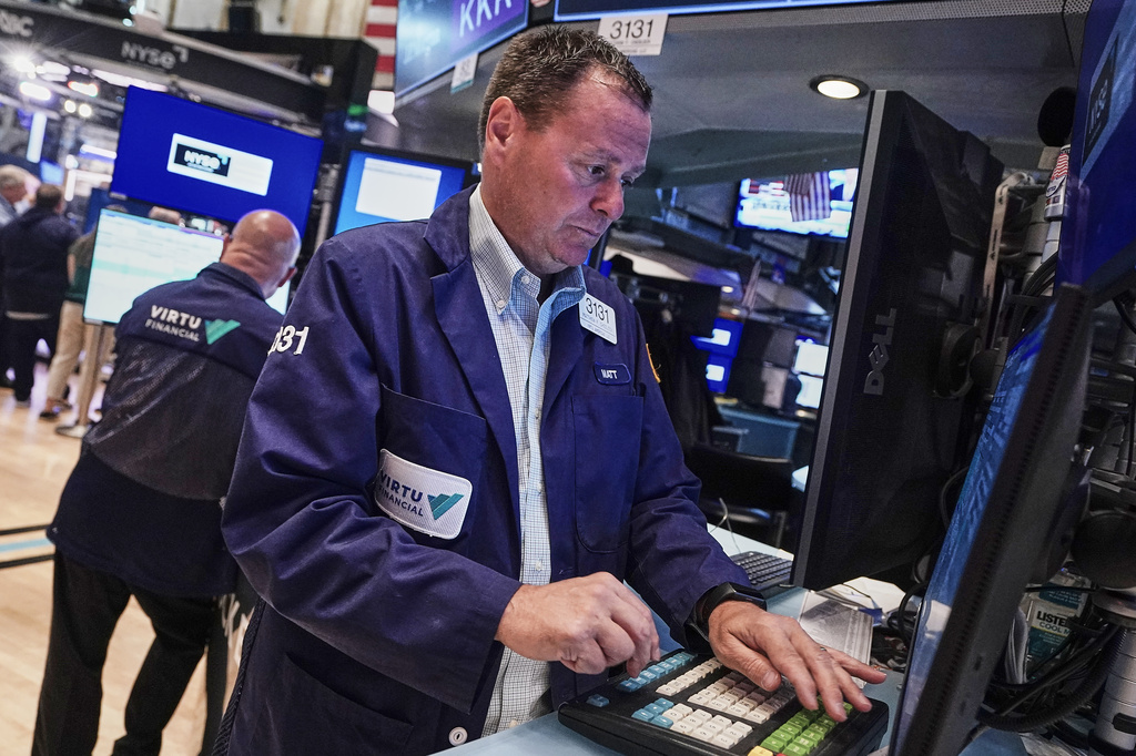 Trader Matthew Cheslock, right, works on the floor of the New York Stock Exchange, Tuesday, June 16, 2026. (AP Photo/Richard Drew)