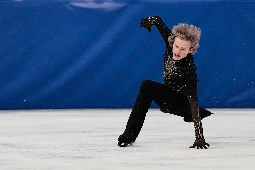 Ilia Malinin of the United States falls during the men's free skate program in figure skating at the 2026 Winter Olympics, in Milan, Italy, Friday, Feb. 13, 2026. (AP Photo/Ashley Landis)