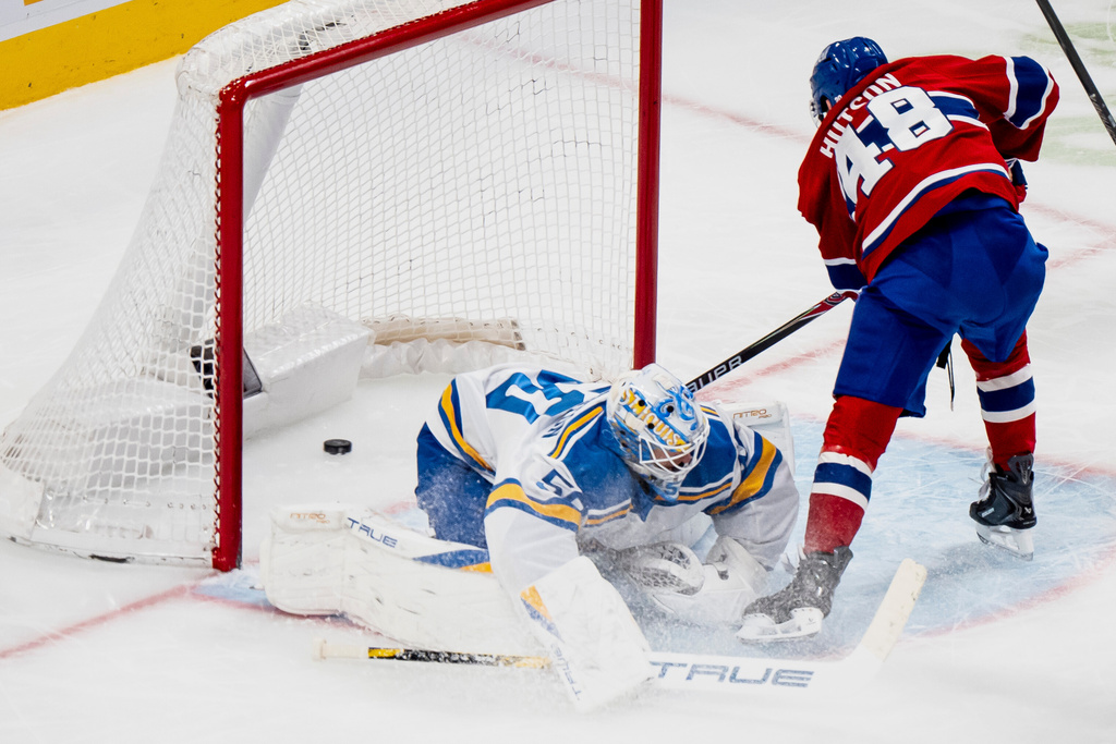 Montreal Canadiens' Lane Hutson (48) scores on St. Louis Blues goaltender Jordan Binnington (50) during the first period of an NHL hockey game, in Montreal, Sunday, Dec. 7, 2025. (Christopher Katsarov/The Canadian Press via AP)