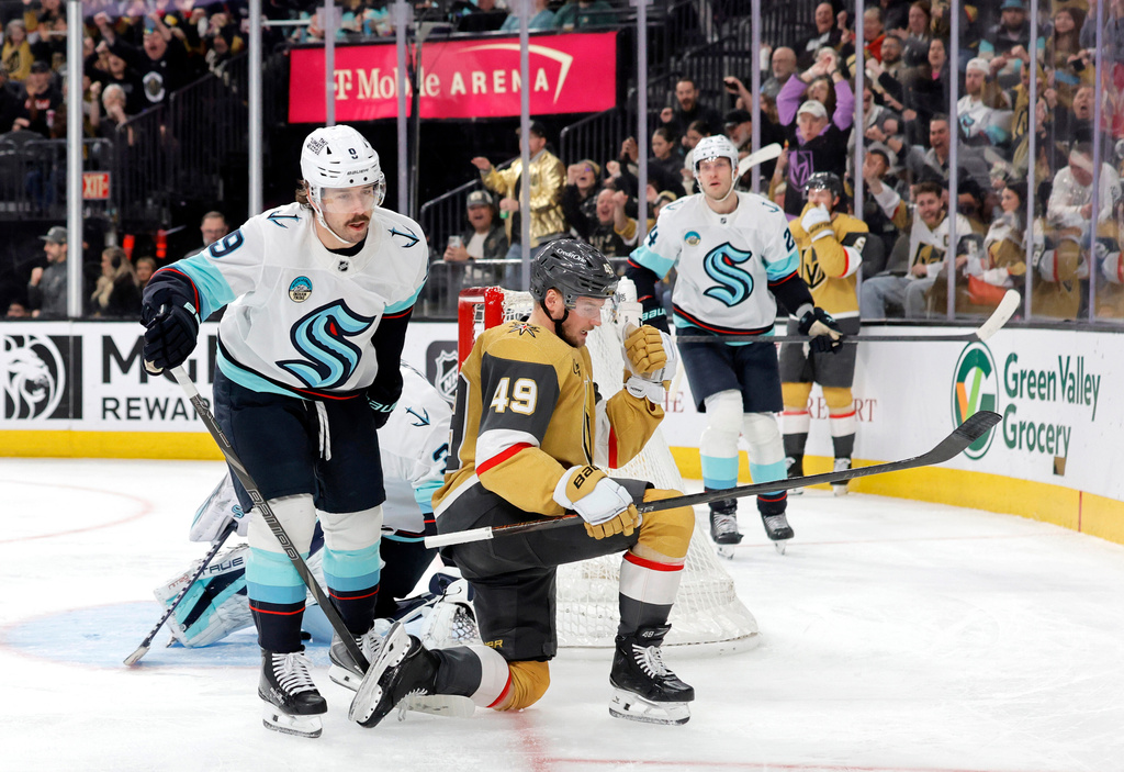Vegas Golden Knights left wing Ivan Barbashev (49) celebrates in front of Seattle Kraken center Chandler Stephenson (9) after scoring against Kraken goaltender Joey Daccord (obscured) during the second period of an NHL hockey game Saturday Jan. 31, 2026, in Las Vegas. (AP Photo/Steve Marcus)