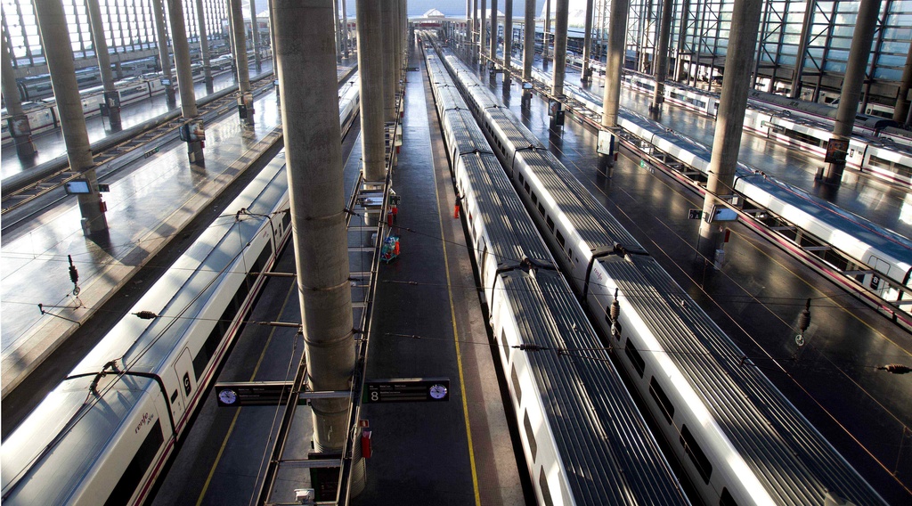 FILE - A worker cleans the windows of a high speed train at Atocha station in Madrid, March 29, 2012. (AP Photo/Paul White, File)