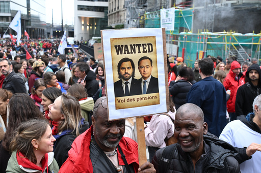 Two men hold a sign with a photo of Belgium's Prime Minister Bart De Wever, which reads 'Pension Theft', during a demonstration and general strike in Brussels, Tuesday, Oct. 14, 2025. (AP Photo/Harry Nakos) Two men hold a sign with a photo of Belgium's Prime Minister Bart De Wever, which reads 'Pension Theft', during a demonstration and general strike in Brussels, Tuesday, Oct. 14, 2025. (AP Photo/Harry Nakos)