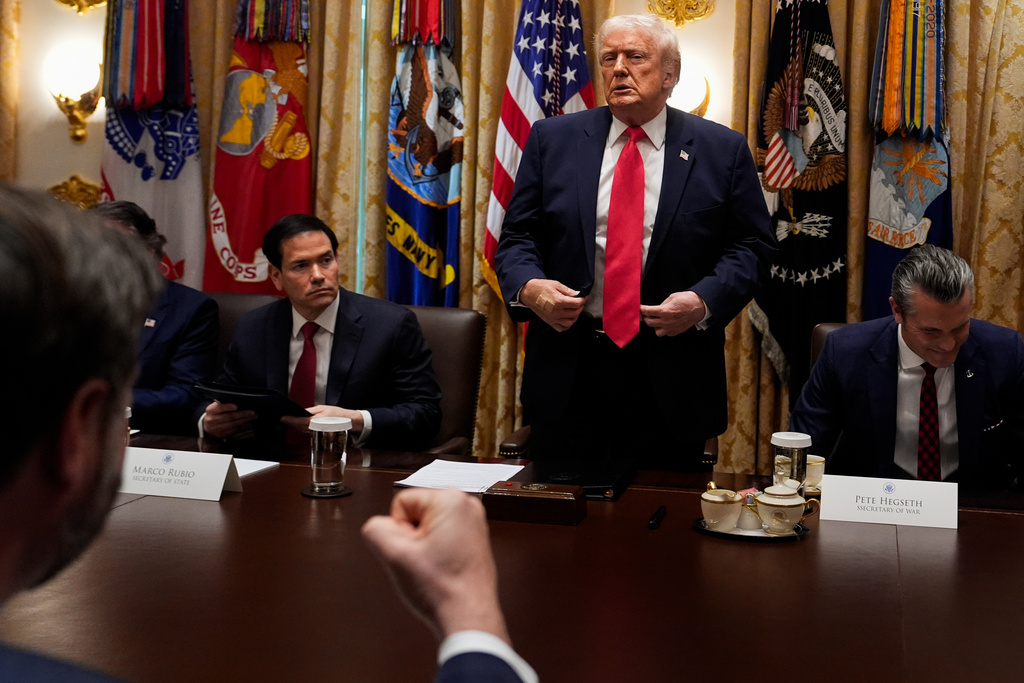 Vice President JD Vance pumps his fist as President Donald Trump stands up following a Cabinet meeting at the White House, Tuesday, Dec. 2, 2025, in Washington. With the President are Secretary of State Marco Rubio, seated left, and Defense Secretary Pete Hegseth, seated right. (AP Photo/Julia Demaree Nikhinson)