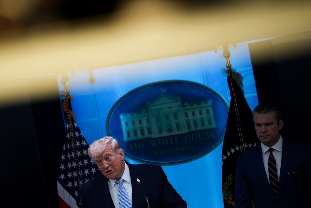 President Donald Trump, accompanied by Defense Secretary Pete Hegseth, speaks with reporters in the James Brady Press Briefing Room at the White House, Monday, April 6, 2026, in Washington. (AP Photo/Julia Demaree Nikhinson)