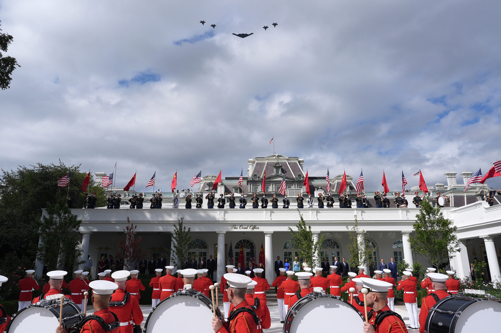 A military flyover is pictured as President Donald Trump, first lady Melania Trump, China's President Xi Jinping and his wife Peng Liyuan watch a military review in the Rose Garden of the White House, Thursday, Sept. 24, 2026, in Washington. (AP Photo/Alex Brandon)