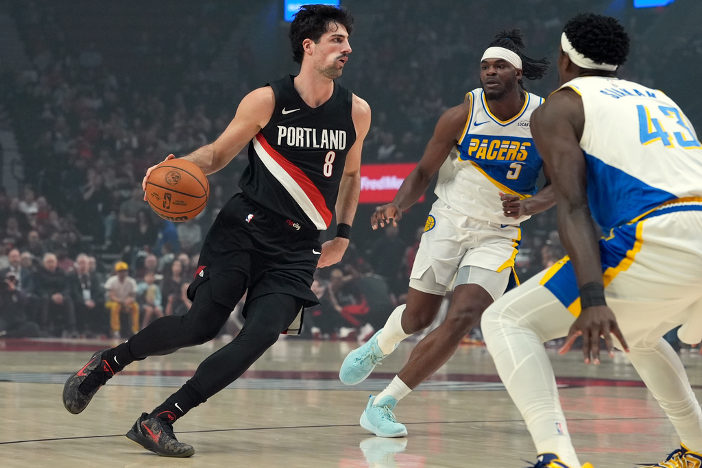 Portland Trail Blazers forward Deni Avdija (8) tries to get past Indiana Pacers forward Jarace Walker (5) during the first half of an NBA basketball game, Sunday, March 8, 2026, in Portland, Ore. (AP Photo/Jenny Kane)