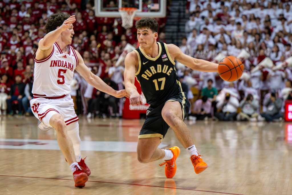 Purdue guard Omer Mayer (17) is defended by Indiana guard Conor Enright (5) during the first half of an NCAA college basketball game, Tuesday, Jan. 27, 2026, in Bloomington, Ind. (AP Photo/Doug McSchooler)