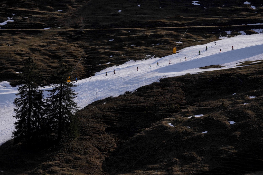 FILE - People ski on a hill with manufactured snow near Bayrischzell, Germany, Feb. 6, 2024. (AP Photo/Matthias Schrader, File)