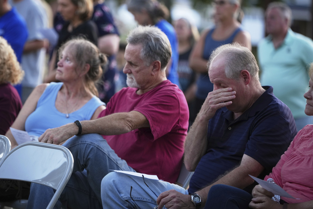 Attendees react during a vigil at Spring Grove Alliance church Thursday, Sept. 18, 2025, in Spring Grove, Pa., after multiple police officers were shot and killed. (AP Photo/Matt Slocum)