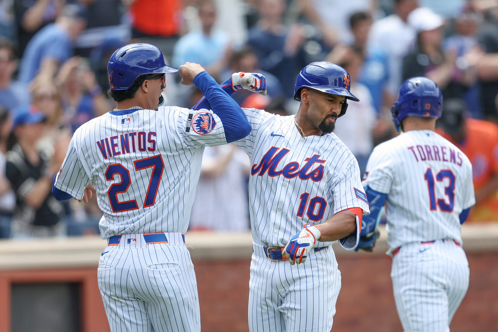 New York Mets' Marcus Semien (10) celebrates his two-run home run with teammate Mark Vientos (27) during the second inning of a baseball game against the Miami Marlins, Sunday, May 31, 2026, in New York. (AP Photo/Heather Khalifa)