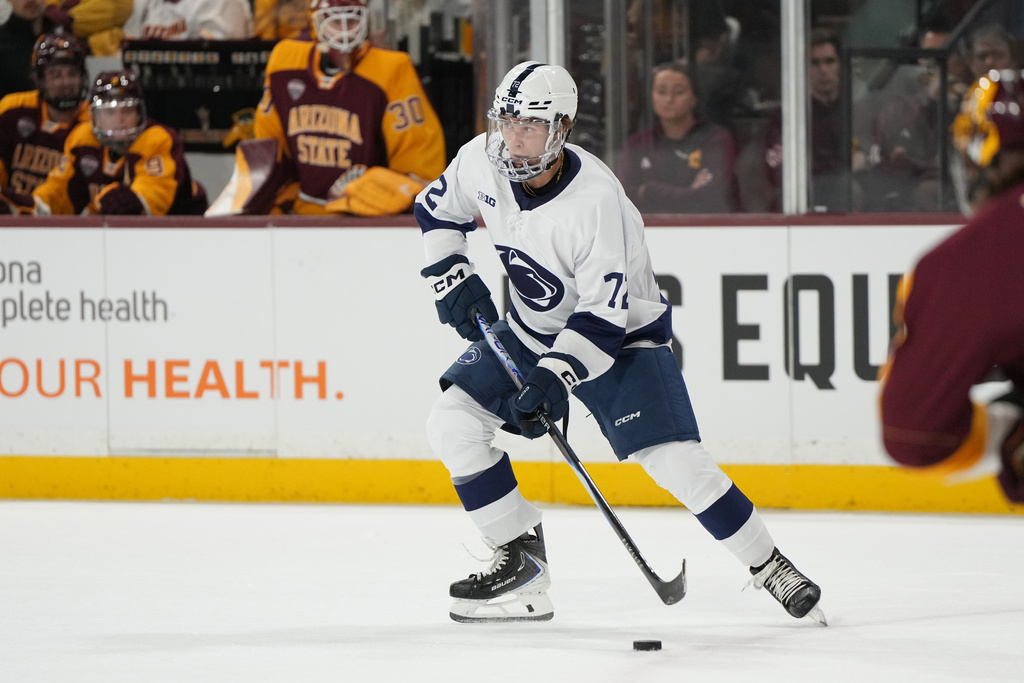 Penn State's Gavin McKenna looks to pass the puck against Arizona State during the first period of an NCAA college hockey game, Friday, Oct. 3, 2025, in Tempe, Ariz. (AP Photo/Rick Scuteri)