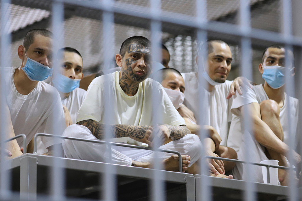FILE - Prisoners look out from their cell as the Costa Rica Justice and Peace minister tours the Terrorism Confinement Center in Tecoluca, El Salvador, April 4, 2025. (AP Photo/Salvador Melendez, File)