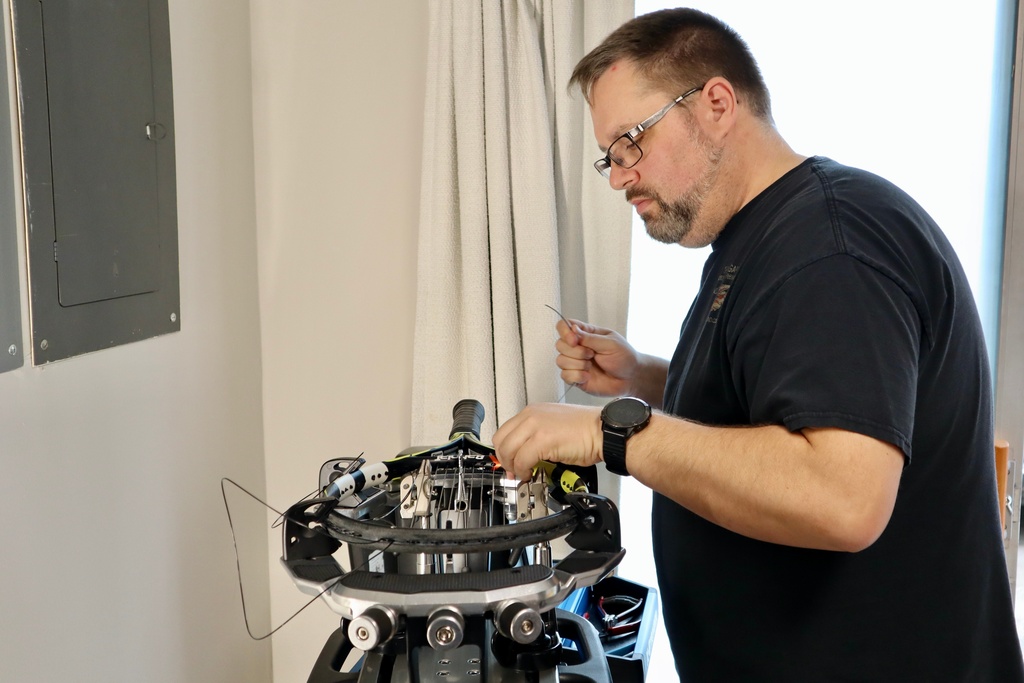 Digital imaging technician Chris Ratledge strings a tennis racket at his home in Peachtree City, Ga., Thursday, March 5, 2026. (AP Photo/R.J. Rico)