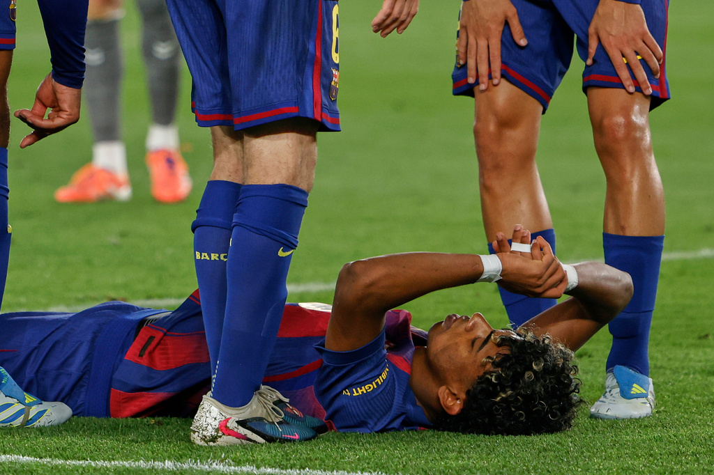 Barcelona's Lamine Yamal lays on the pitch after getting injured during the Spanish La Liga soccer match between Barcelona and Celta Vigo in Barcelona, Spain, Wednesday, April 22, 2026. (AP Photo/Joan Monfort)