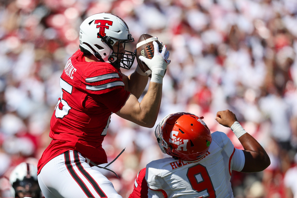 Texas Tech linebacker Austin Romaine (15) intercepts pass over Sam Houston State's Brett Holloway during the first half of an NCAA college football game, Saturday, Sept. 26, 2026, in Lubbock, Texas. (AP Photo/Chase Seabolt)