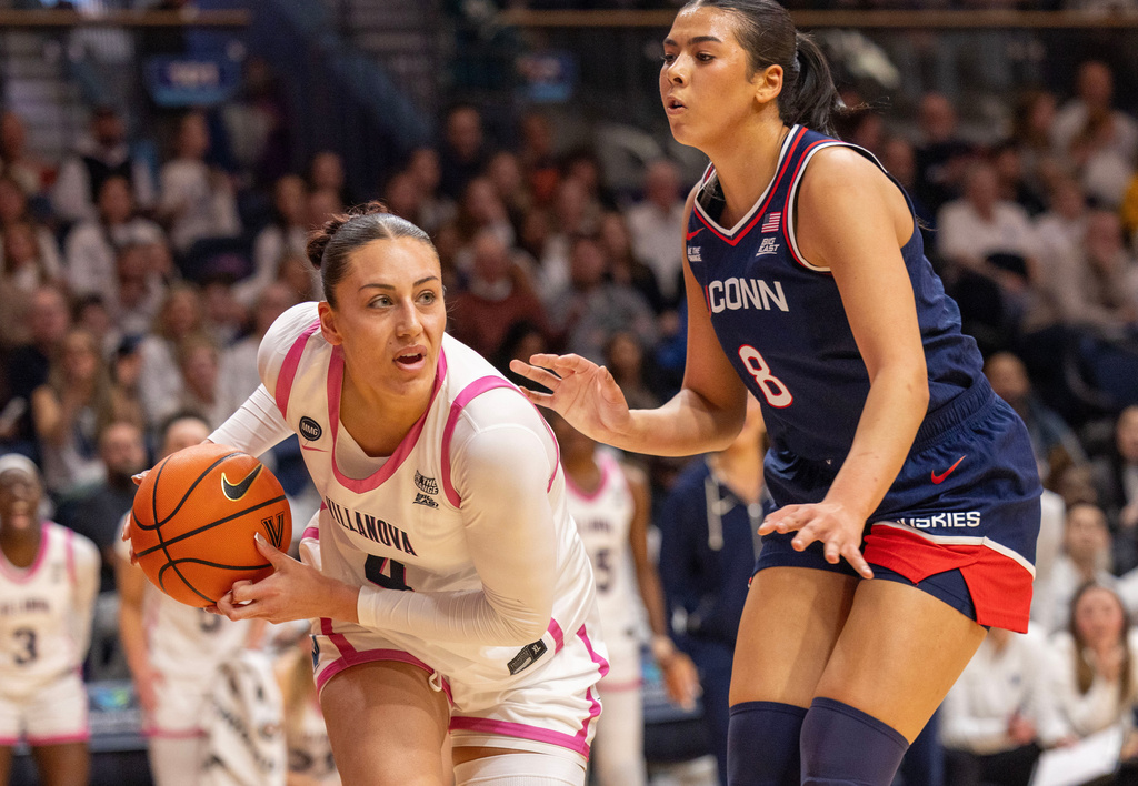 Villanova forward Kylee Watson (4) keeps the ball away from UConn center Jana El Alfy (8) during the first half of an NCAA college basketball game, Wednesday, Feb. 18, 2026, in Villanova, Pa. (AP Photo/Laurence Kesterson)