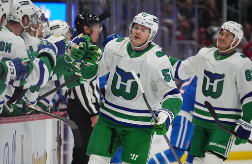 Carolina Hurricanes left wing Eric Robinson is congratulated as he passes the team box after scoring a goal against the Colorado Avalanche in the first period of an NHL hockey game Thursday, Oct. 23, 2025, in Denver. (AP Photo/David Zalubowski) Carolina Hurricanes left wing Eric Robinson is congratulated as he passes the team box after scoring a goal against the Colorado Avalanche in the first period of an NHL hockey game Thursday, Oct. 23, 2025, in Denver. (AP Photo/David Zalubowski)