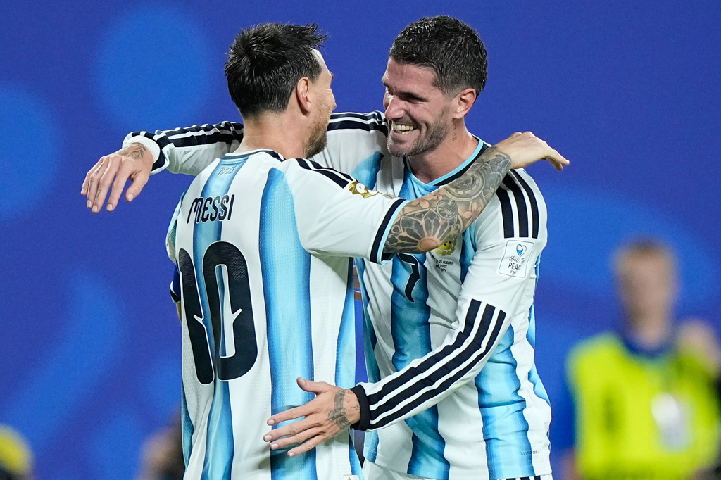 Argentina's Lionel Messi, left, is embraced by teammate Rodrigo de Paul after scoring his third goal during the World Cup Group J soccer match between Argentina and Algeria in Kansas City, Mo., Tuesday, June 16, 2026. (AP Photo/Charlie Riedel)