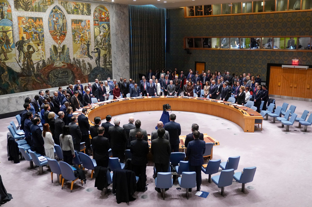FILE - Participants in a Security Council meeting rise for a moment of silence at United Nations headquarters, Feb. 24, 2023. (AP Photo/Seth Wenig, File)