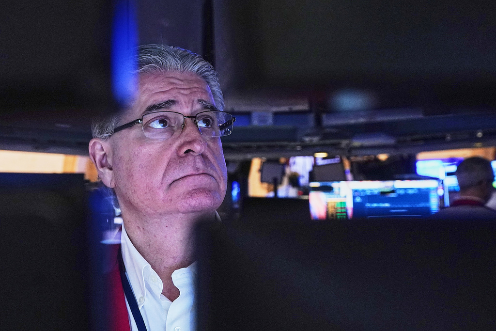 Trader Daniel Krieger is framed by his computer monitors as he works on the floor of the New York Stock Exchange, Wednesday, Jan. 21, 2026. (AP Photo/Richard Drew)