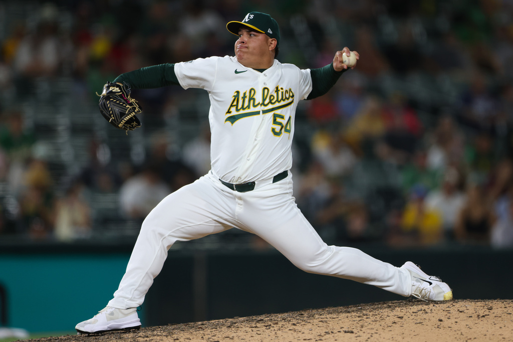 Athletics pitcher José Suarez throws to a Boston Red Sox batter during the 10th inning of a baseball game Wednesday, July 29, 2026, in West Sacramento, Calif. (AP Photo/Scott Marshall)