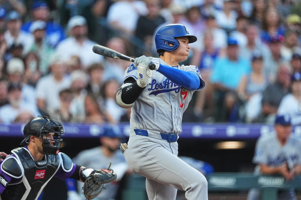 Los Angeles Dodgers' Shohei Ohtani singles off Colorado Rockies starting pitcher Tomoyuki Sugano in the third inning of a baseball game Monday, Aug. 17, 2026, in Denver. (AP Photo/David Zalubowski)