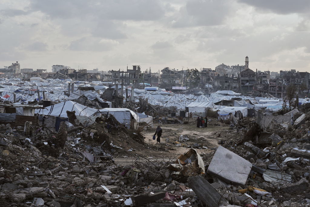 A tent camp for displaced Palestinians stand amid the destruction left by Israeli strikes north of Gaza City Tuesday, Nov. 25, 2025. (AP Photo/Jehad Alshrafi)