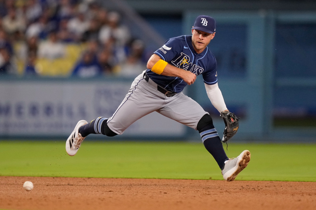 Tampa Bay Rays shortstop Taylor Walls fields a ball hit by Los Angeles Dodgers' Andy Pages before throwing him out at first during the sixth inning of a baseball game Tuesday, June 16, 2026, in Los Angeles. (AP Photo/Mark J. Terrill)