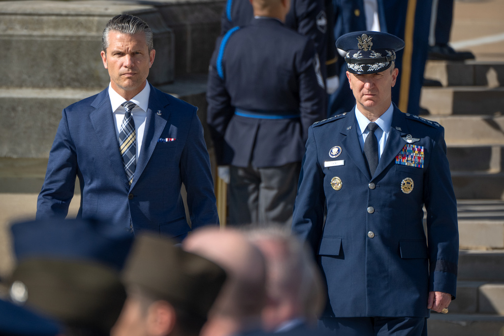 Defense Secretary Pete Hegseth, left, and Chairman of the Joint Chiefs of Staff Gen. Dan Caine, right, arrive for the POW/MIA National Recognition Day Ceremony at the Pentagon, Friday, Sept. 18, 2026, in Washington. (AP Photo/Mark Schiefelbein)