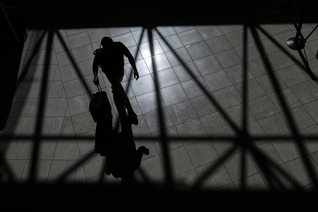 A traveler walks through the Baltimore/Washington International Thurgood Marshall Airport, Thursday, Oct. 2, 2025, in Baltimore. (AP Photo/Stephanie Scarbrough)