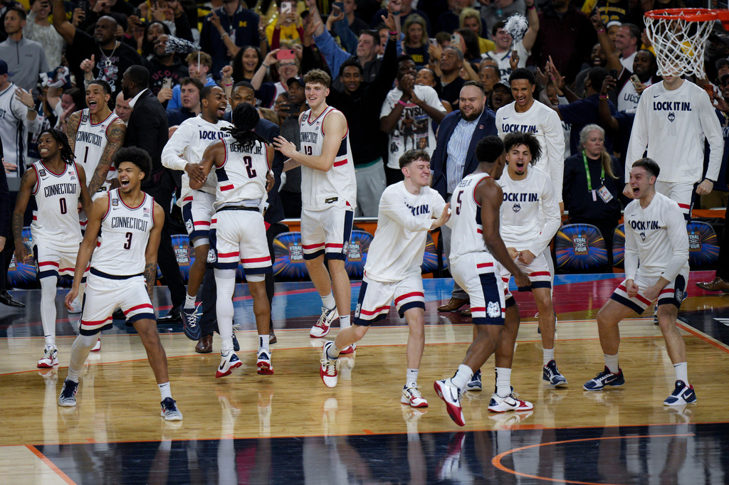 UConn players celebrates their win after the second half of an NCAA college basketball tournament semifinal game against Illinois at the Final Four, Saturday, April 4, 2026, in Indianapolis. (AP Photo/AJ Mast)