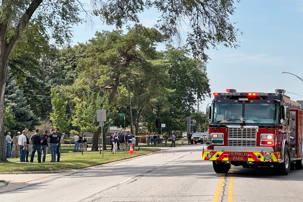 Law enforcement responds to the scene where an Immigration and Customs Enforcement officer shot and killed a suspect after the suspect drove his car at the arresting officers on Friday, Sept. 12, 2025, in Franklin Park, Ill. (AP Photo/Laura Bargfeld)