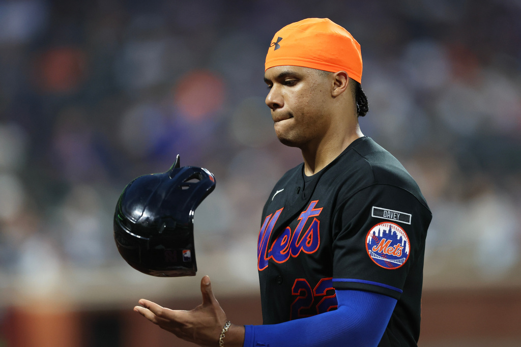 New York Mets' Juan Soto flips his helmet during a pitching change in the fifth inning of a baseball game against the Chicago Cubs, Thursday, June 25, 2026, in New York. (AP Photo/Heather Khalifa)