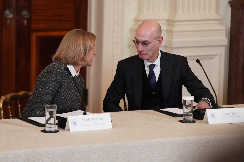Chief Executive Officer of U.S. Olympic & Paralympic Committee Sarah Hirshland speaks with NBA commissioner Adam Silver before a roundtable discussion on college sports in the East Room of the White House, Friday, March 6, 2026, in Washington. (AP Photo/Julia Demaree Nikhinson)