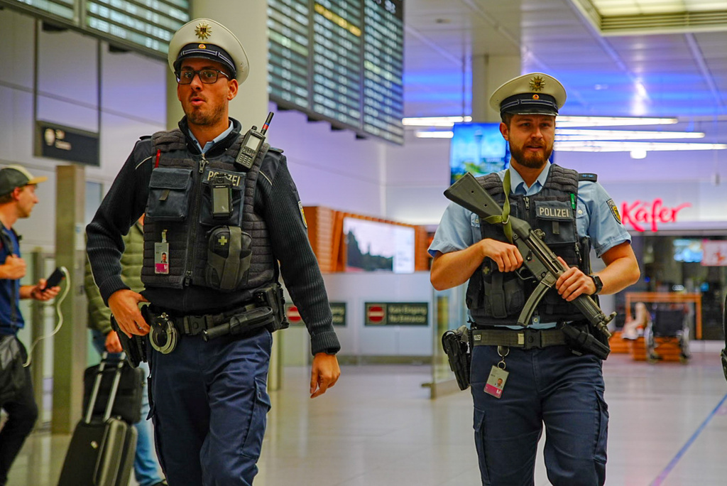 Police officers patrol Munich Airport after the airport shut down operations due to possible new drone sightings Friday, Oct. 3, 2025, in Munich. (Enrique Kaczor/dpa via AP)