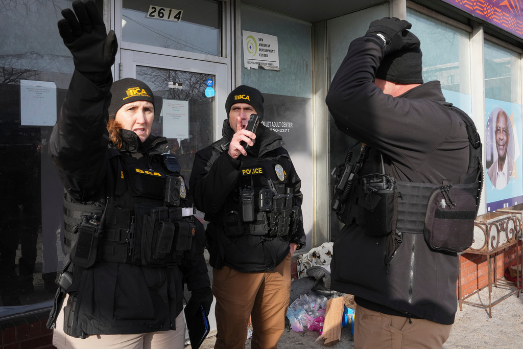 BCA officers stand near the scene of a fatal shooting that took place yesterday, in Minneapolis, Sunday, Jan. 25, 2026. (AP Photo/Adam Gray)