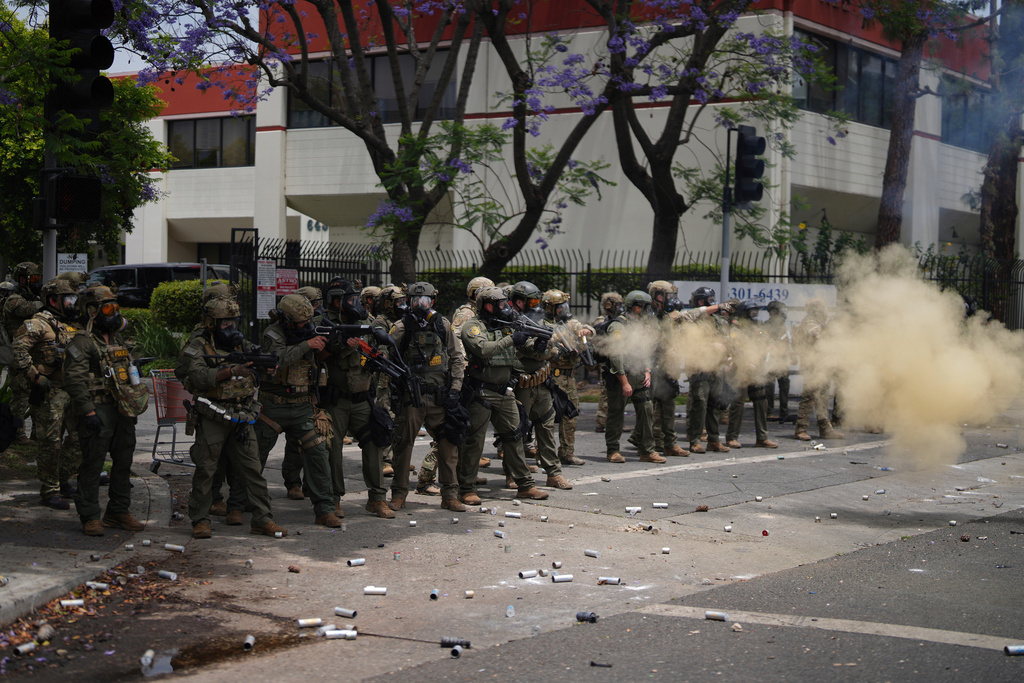 FILE - Border Patrol personnel deploy tear gas during a demonstration over the dozens detained in an operation by federal immigration authorities a day earlier, in Paramount, Calif., June 7, 2025. (AP Photo/Eric Thayer, File)