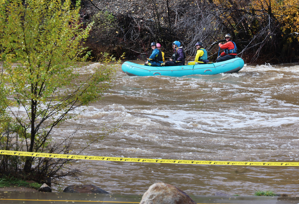 Rafters make their way down a closed Animas River Saturday, Oct. 24, 2026, in Durango, Colo. (Jerry McBride/The Durango Herald via AP)