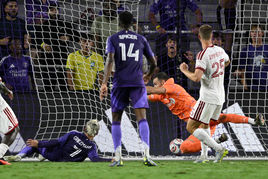 Orlando City forward Antoine Griezmann (7) scores a goal past Toronto FC goalkeeper Luka Gavran, second from right, during the first half of an MLS soccer match, Saturday, Sept. 12, 2026, in Orlando, Fla. (AP Photo/Phelan M. Ebenhack)