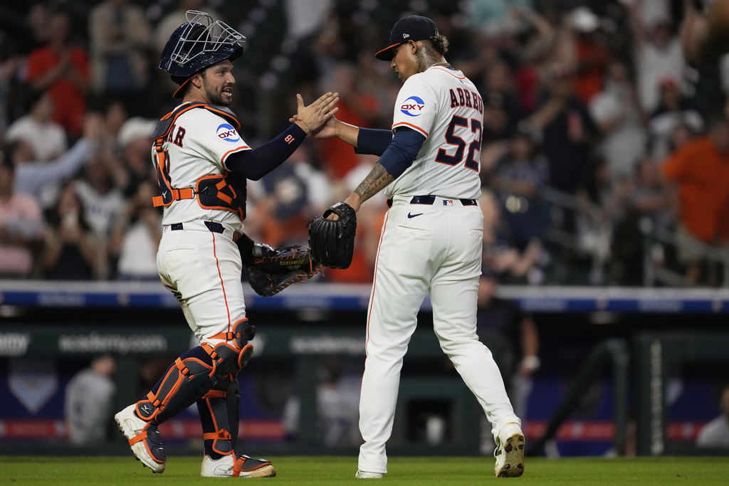 Houston Astros catcher César Salazar celebrates with relief pitcher Bryan Abreu (52) after winning of a baseball game against the Colorado Rockies in Houston, Wednesday, Aug. 27, 2025. (AP Photo/Ashley Landis)