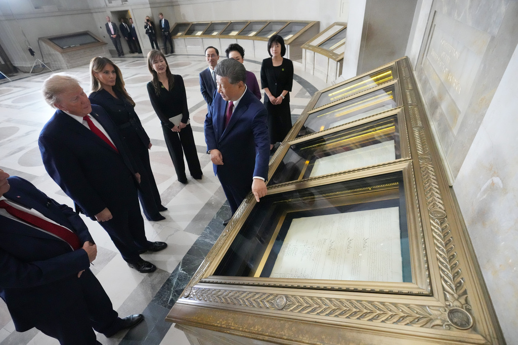 President Donald Trump, first lady Melania Trump, China's President Xi Jinping and his wife Peng Liyuan, with Bradford Wilson, Archivist of the United States, view the Constitution, Bill of Rights and other documents at the National Archives, Friday, Sept. 25, 2026, in Washington. (AP Photo/Alex Brandon)