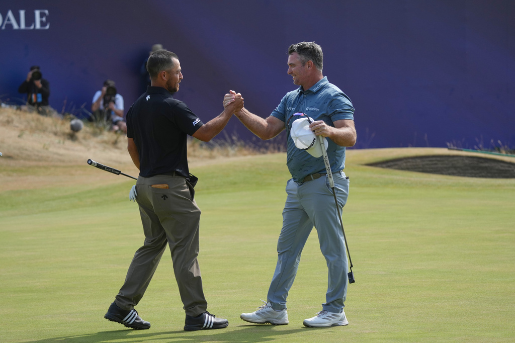 Xander Schauffele of the United States, left, and Ryan Fox of New Zealand shake hands after complete their third rounds on the 18th green during the third day of the British Open Golf championships at Royal Birkdale golf club, in Southport, England, Saturday, July 18, 2026. (AP Photo/Jon Super)