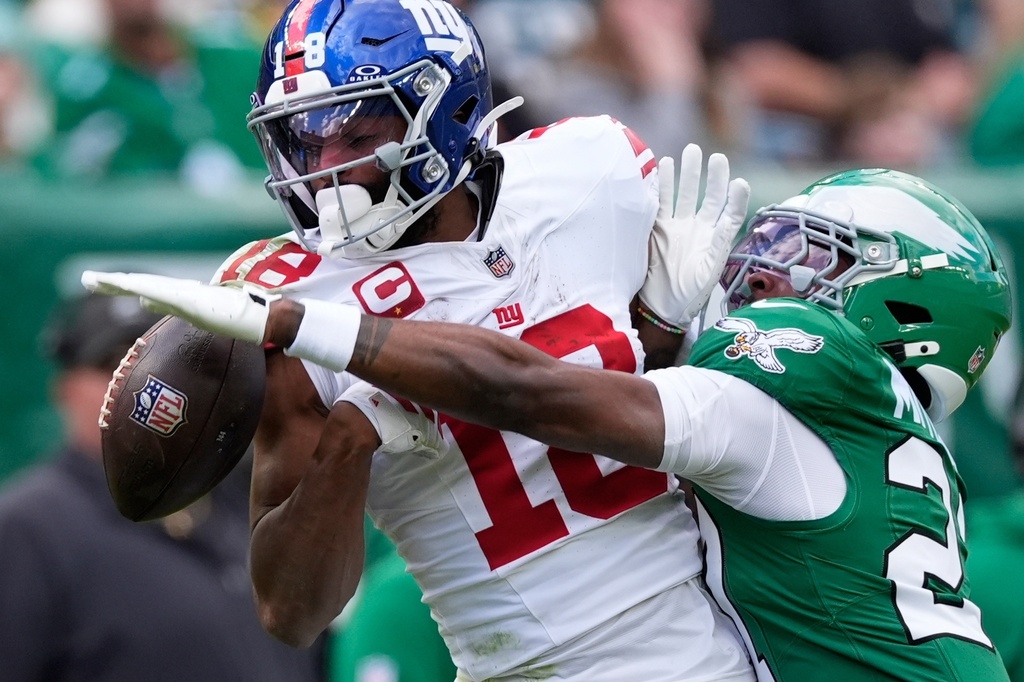 Philadelphia Eagles cornerback Quinyon Mitchell (27) breaks up the pass for New York Giants wide receiver Darius Slayton (18) during the first half of an NFL football game Sunday, Oct. 26, 2025, in Philadelphia. (AP Photo/Chris Szagola)