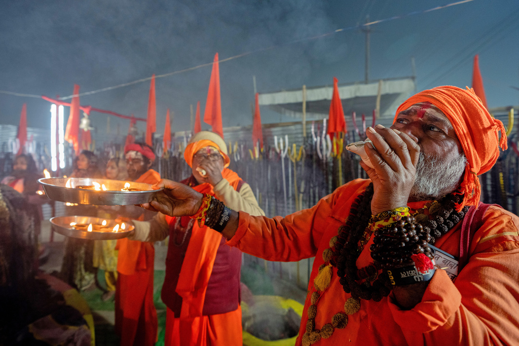 Hindu holy men pray on the eve of Mauni Amavasya, a divine occasion in Hindu religious practice followed for honoring ancestors or forefathers, at the Sangam, the confluence of the Ganges, the Yamuna and the mythical Saraswati rivers, during the annual month long Hindu religious fair "Magh Mela" in Prayagraj, India, Saturday, Jan.17, 2026. (AP Photo/Rajesh Kumar Singh)