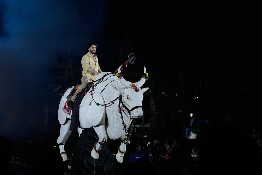 Tollywood superstar Mahesh Babu rides a mechanical bull at the unveiling of first look of film "Varanasi" in Hyderabad, India, Saturday, Nov. 15, 2025. (AP Photo/Mahesh Kumar A.)