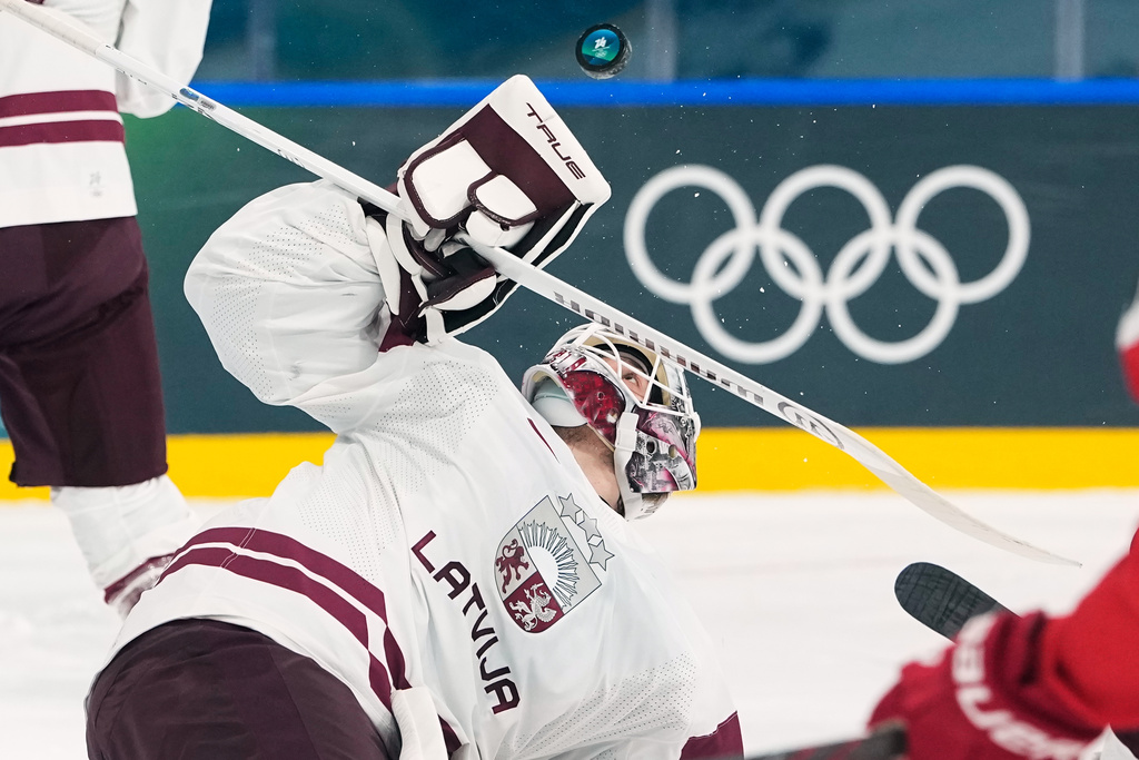 Latvia's goalkeeper Arturs Silovs makes a save during a preliminary round match of men's ice hockey between Denmark and Latvia at the 2026 Winter Olympics, in Milan, Italy, Sunday, Feb. 15, 2026. (AP Photo/Petr David Josek)
